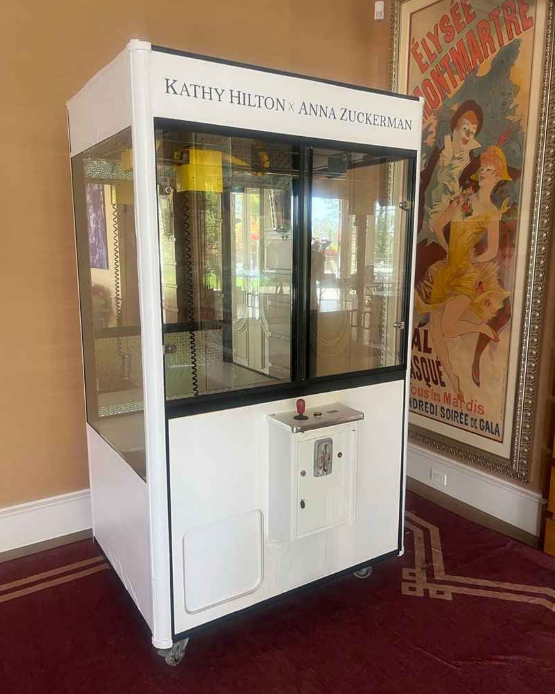 A custom white claw machine labeled “Kathy Hilton x Anna Zuckerman,” photographed indoors before being filled for her 65th birthday party.