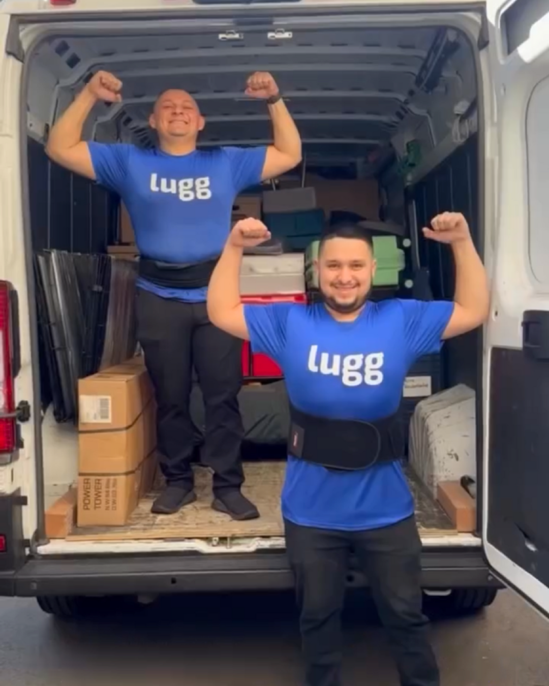 Lugg movers Oscar and Jorge flex their arms while standing in the back of a fully loaded moving van after helping Real Housewives star Gina Kirschenheiter with her move.