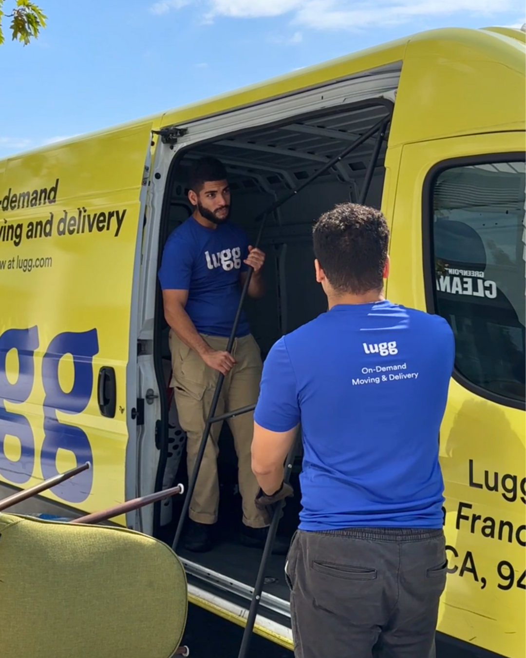 Lugg movers loading items into a yellow Lugg van for college move-in day.