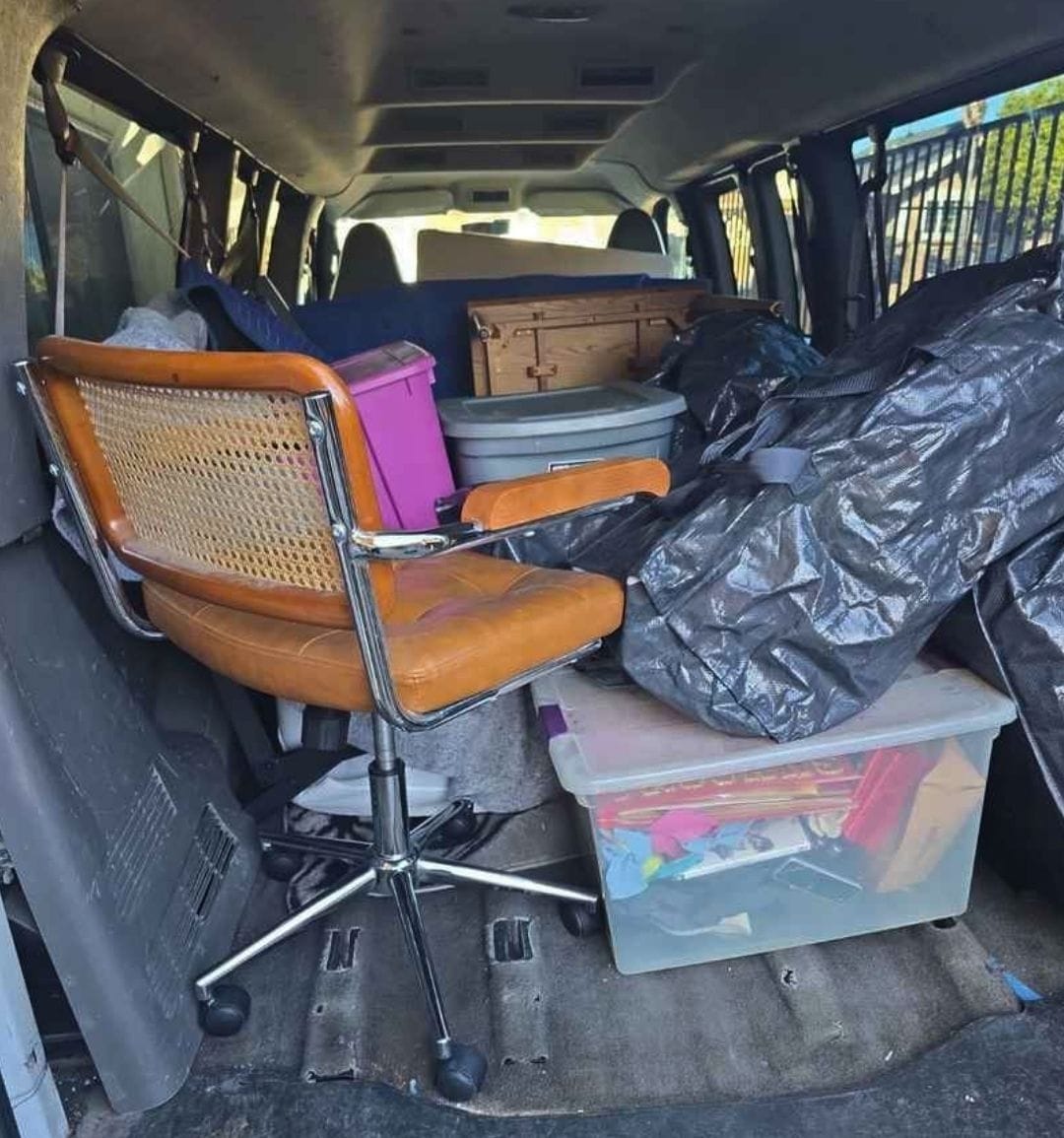 Lugg moving van interior with furniture and boxes, showing enclosed space for medium-sized moves.