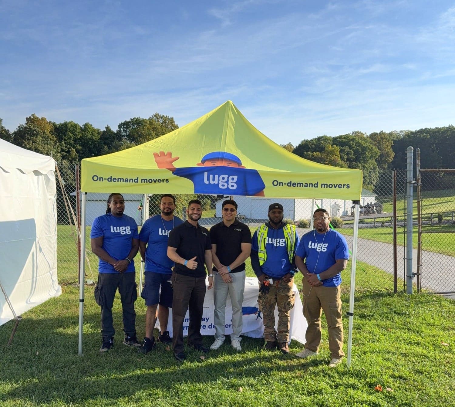 Lugg crew standing under the Lugg tent at the Large Item Pickup area of the 2026 Country Living Fair in Rhinebeck, NY