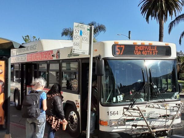 Passengers board an AC Transit bus
