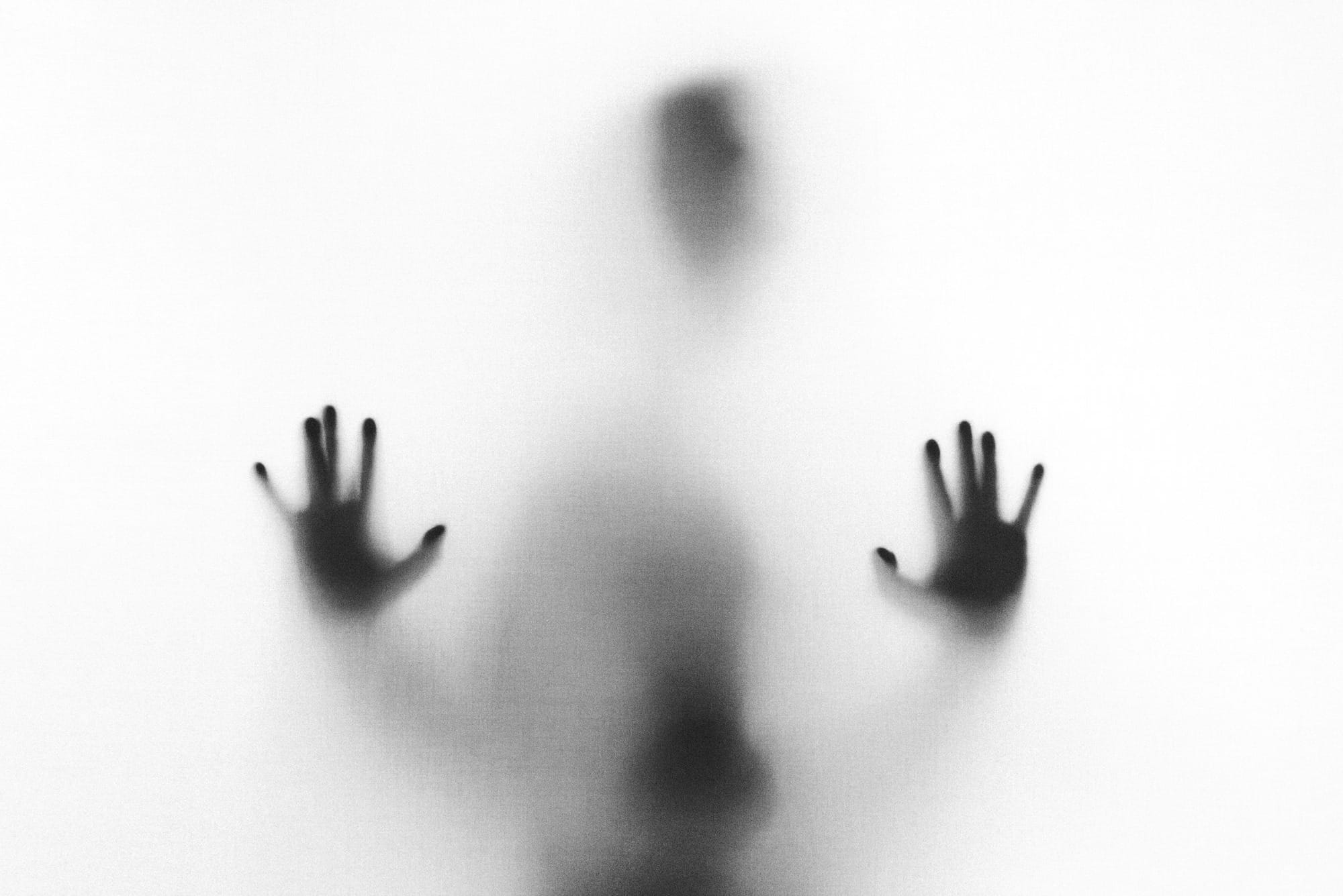 person behind fog glass