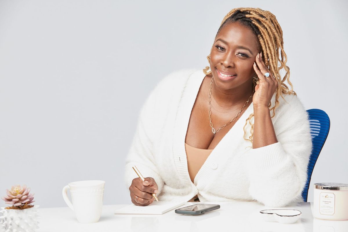 Regina Lawless Toney sitting at a desk looking at the camera