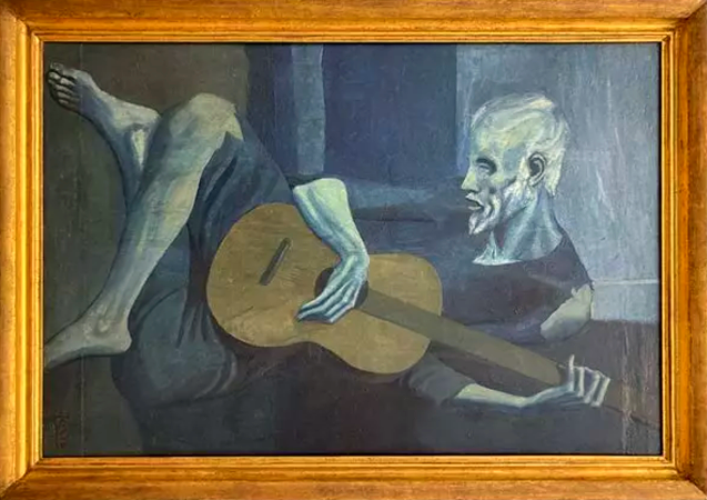 Oil painting in muted hues of blue and neutral brown, inside a brown wood frame.  Displayed horizontally, and olde man in a torn blue tunic reclines with crossed legs playing guitar.