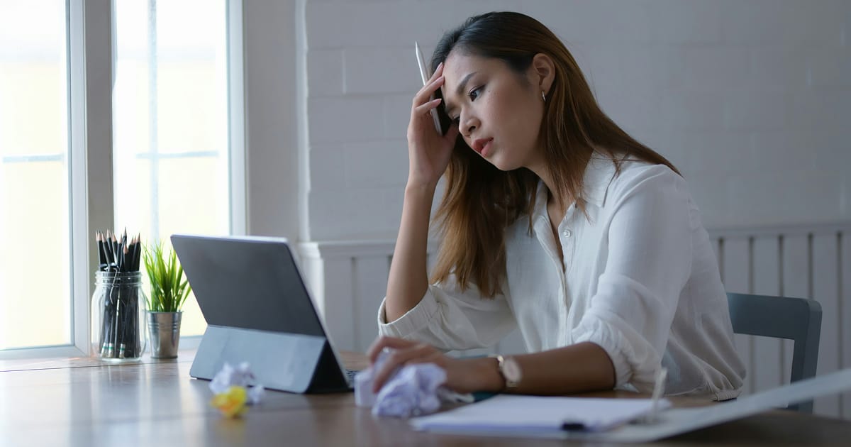 A frustrated businessperson encountering an account ownership challenge on her tablet