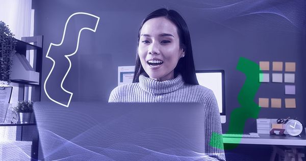 A woman in an office using website automation tools to navigate a site on her laptop.