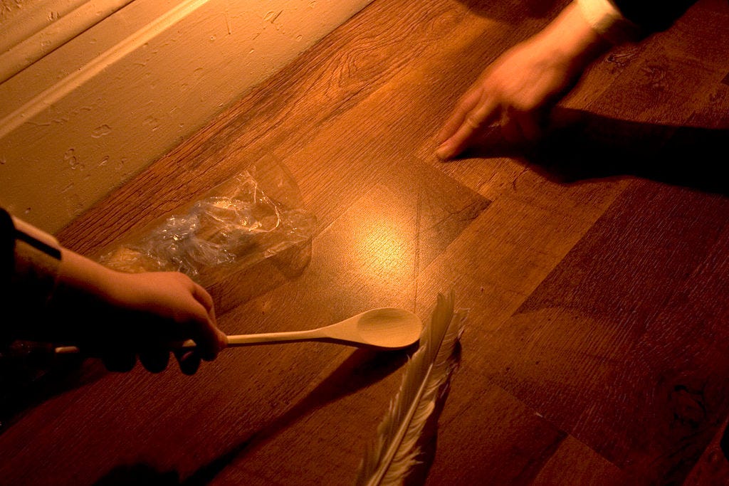 Hands, feather, candle, spoon, looking for crumbs of chametz