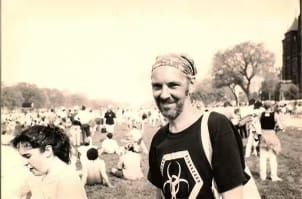 Black and white photo of a white man with a bandanna on his head