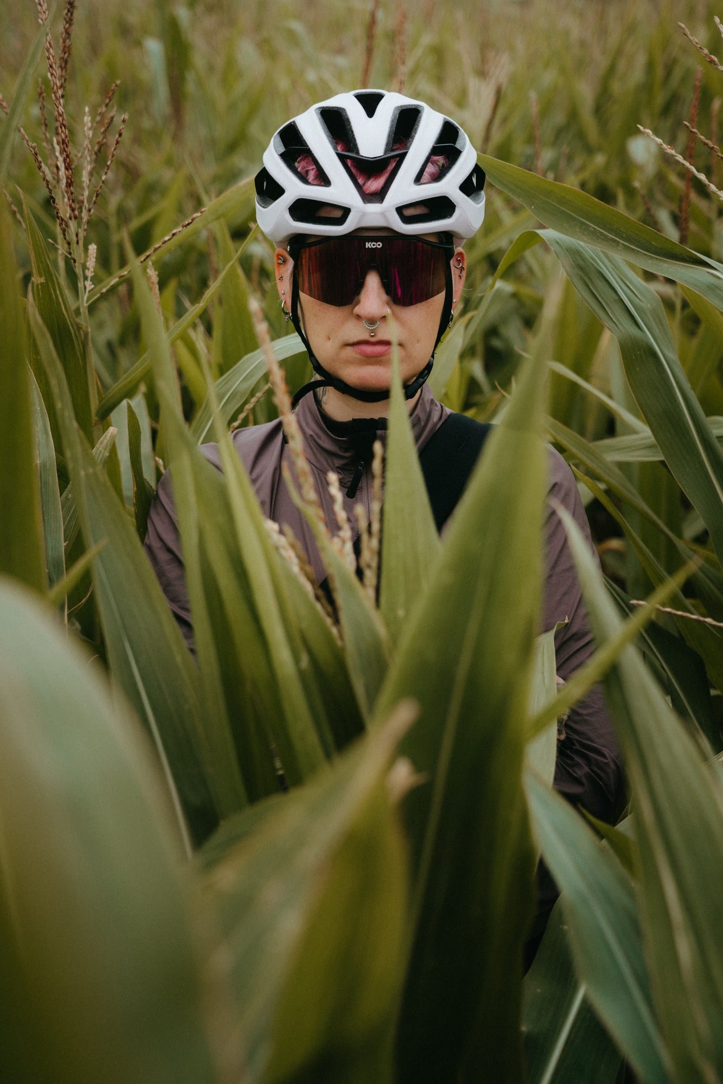 Jana framed by leaves in a cornfield