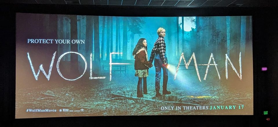 Promo image for Wolf Man (2025) featuring the two leads Matilda Firth as Ginger and Julia Garner as Charlotte in the woods.