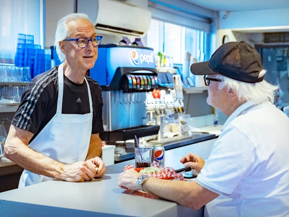 Paolo Momesso speaks with longtime customer Robert Proulx at the city's famed submarine sandwich restaurant on Thursday