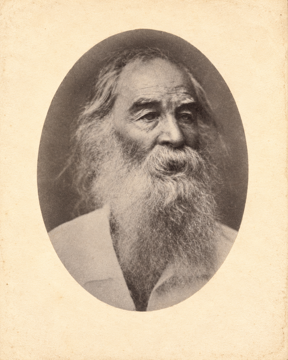 An oval sepia portrait of Walt Whitman on warm ivory paper.