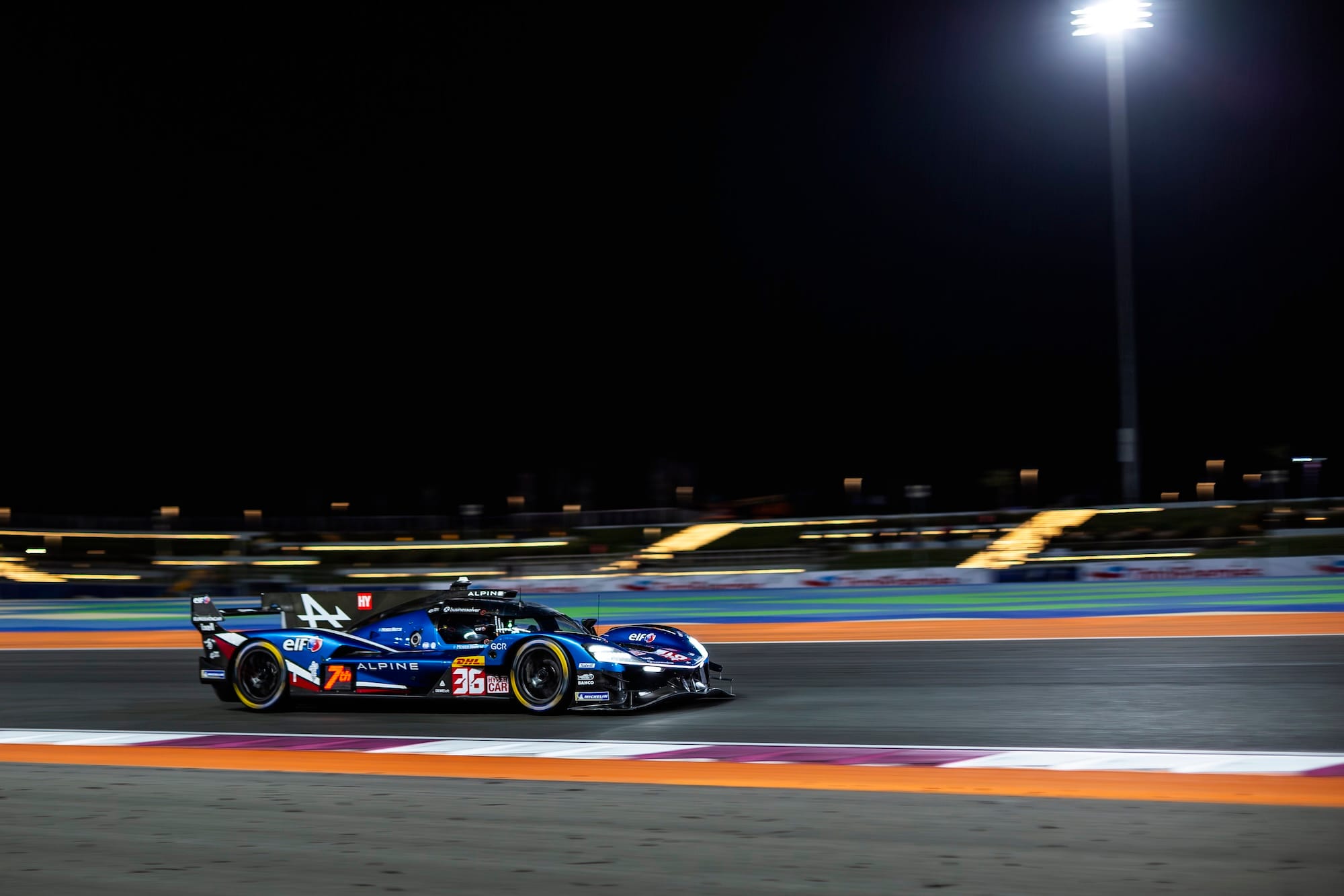 #36 Alpine A424 at Lusail International Circuit, in darkness, lid by floodlights.