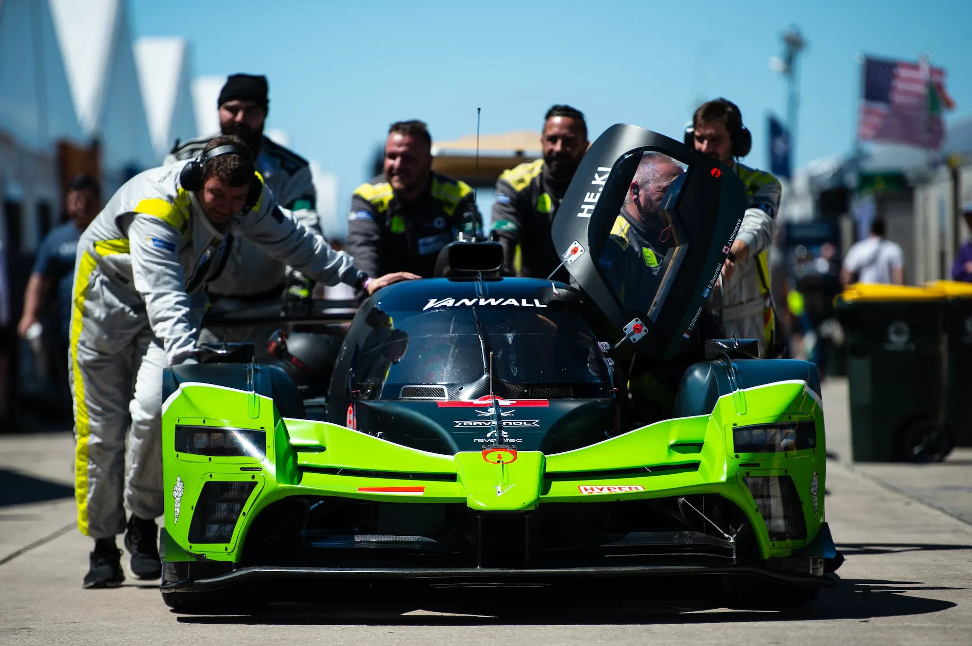 The Vanwall Vandervell 680 being pushed by mechanics with the left-hand side door open, at Sebring 2023