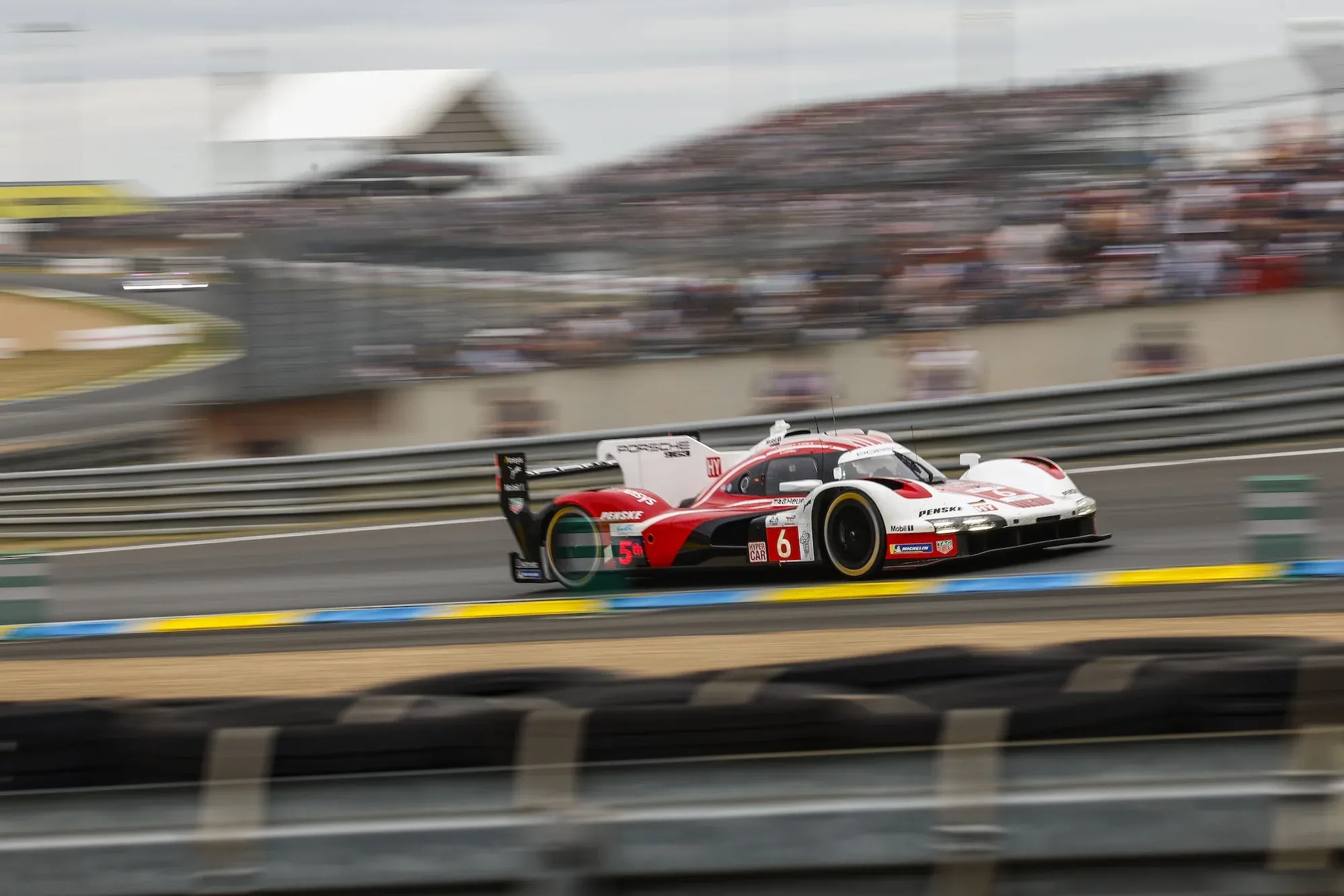 The #6 Porsche 963 in day time at Le  Mans, having just gone through the Forest Esses and now on the way to Tertre Rouge