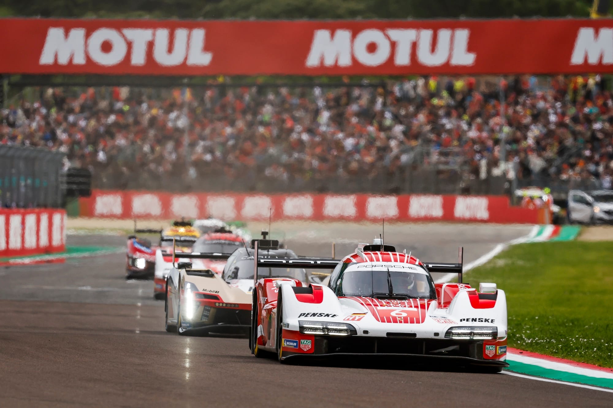 #6 Porsche 963 on Imola main straight, ahead of Cadillac V-Series.R, the sister #5 Porsche 963, and a Ferrari 499P