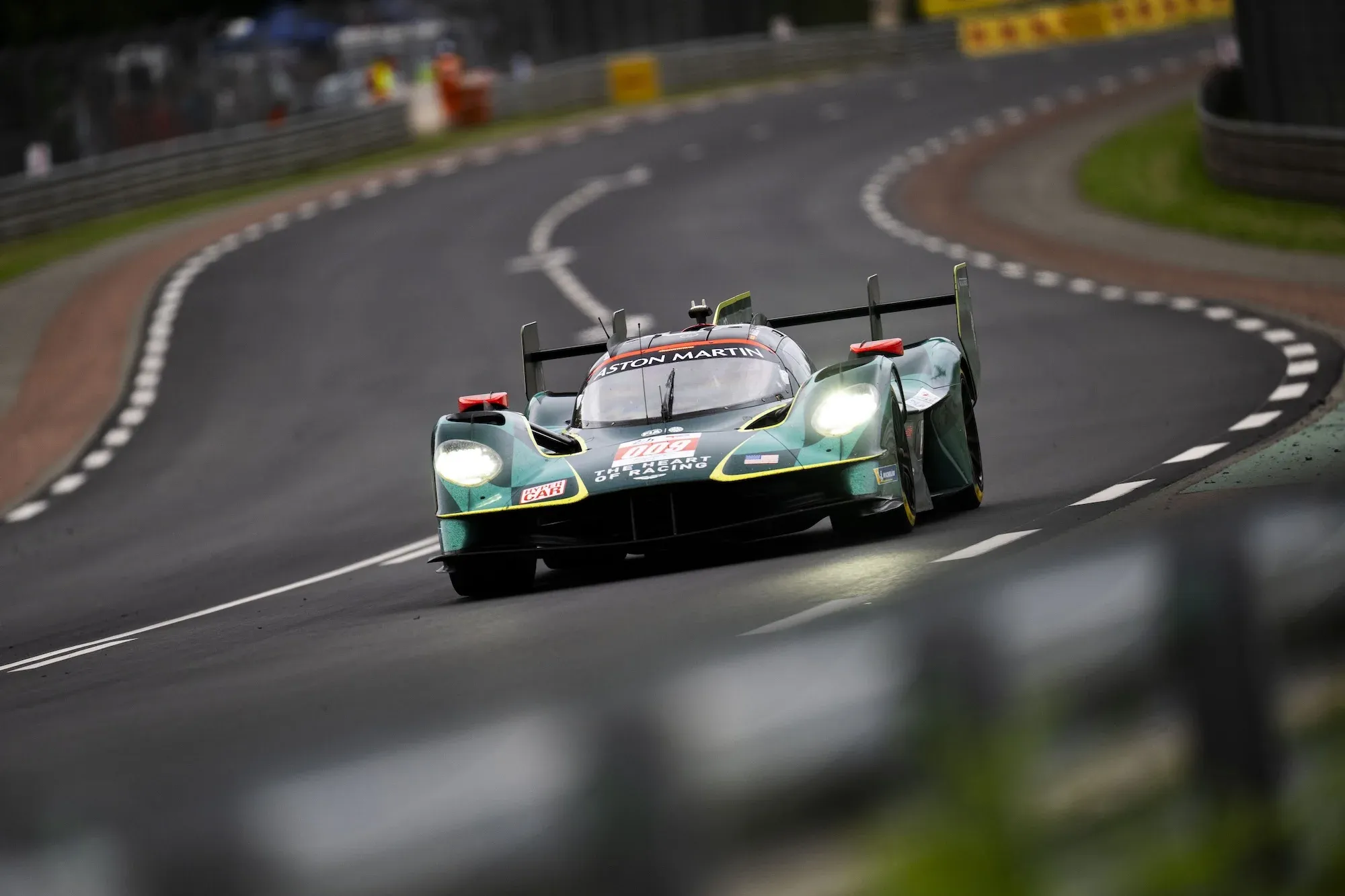 The #009 Aston Martin Valkyrie entering Porsche Curves at Le Mans 2025, in daylight