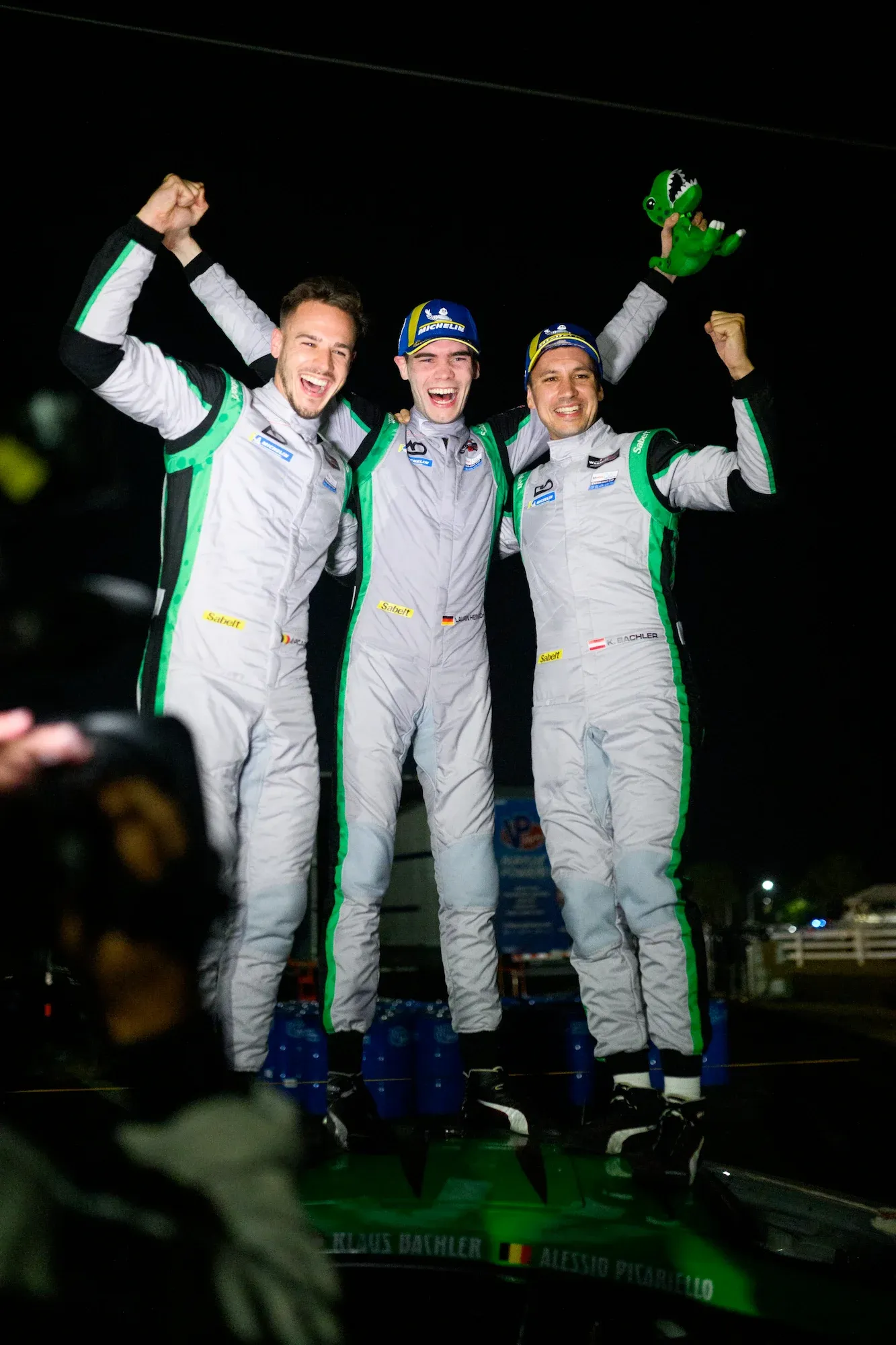 Lauren Heinrich (middle) and Klaus Bachler (right) celebrate a win with an endurance co-driver