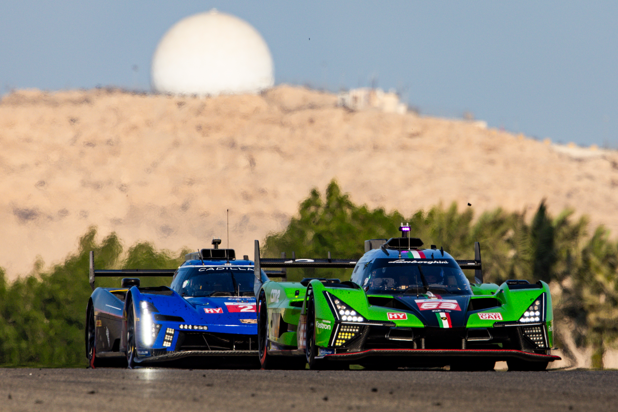Lamborghini SC63 and Cadillac V-Series.R, behind, racing each other in WEC