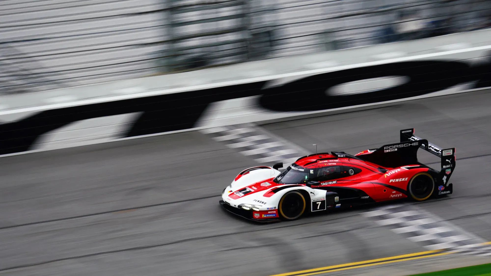 The v#7 Porsche crossing the finish line at Daytona International Speedway. Image: Kevin Dejewski