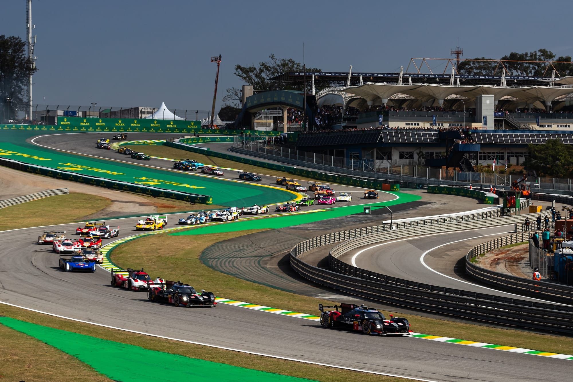 The cars at the start of the 6H Sao Paulo WEC race last year exiting the Senna S, with Toyota leading