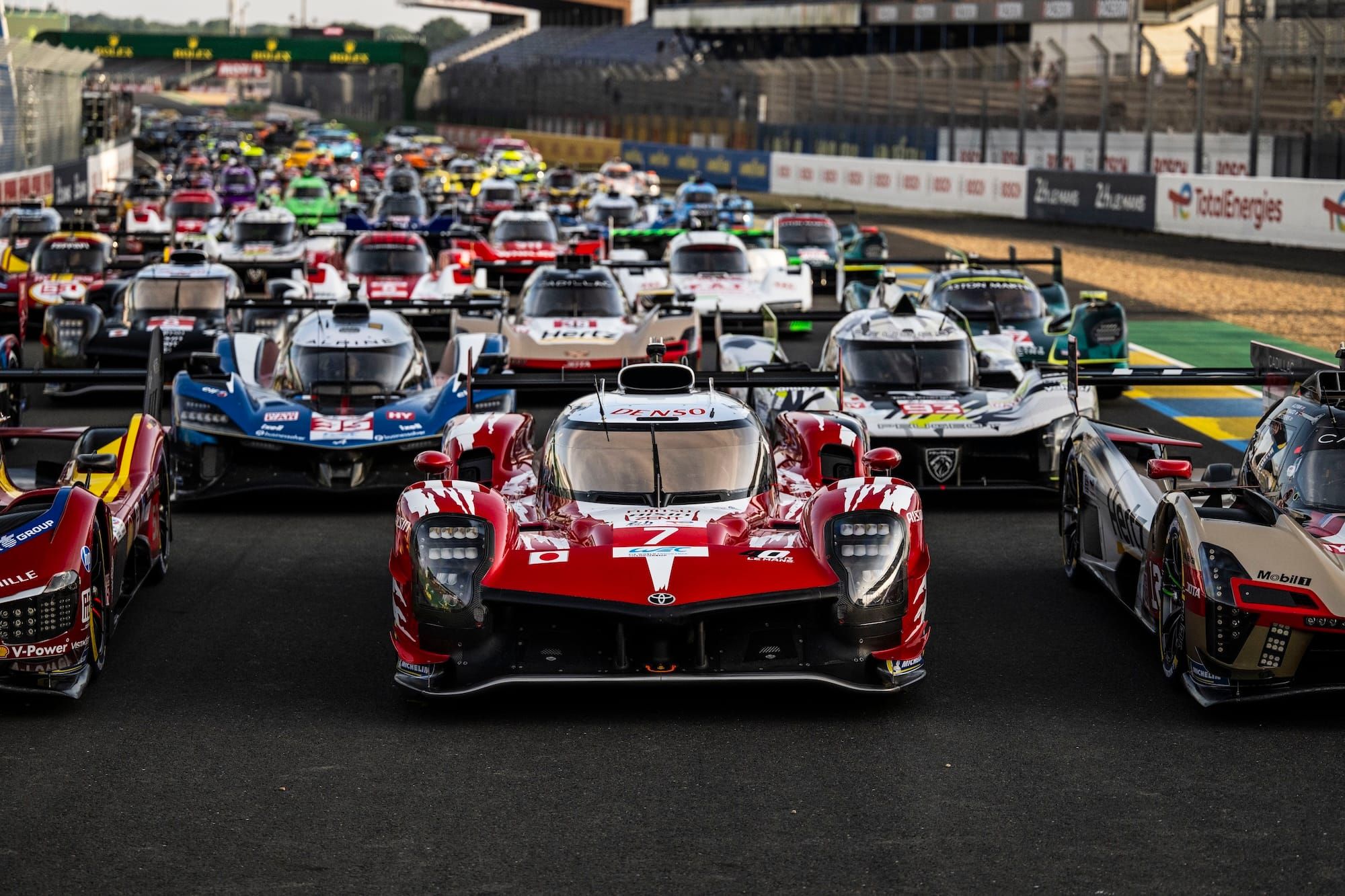 The #7 Toyota GR010, in Toyota GT-One tribute livery, centre shot in the traditional Le Mans photo in the week before the race, surrounded by other Hypercars