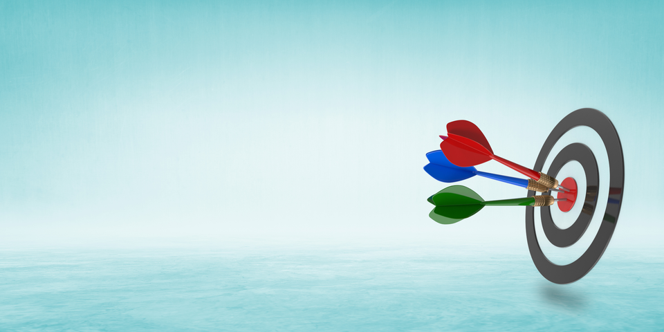 Target with three darts stuck in its centre, on a pale blue background