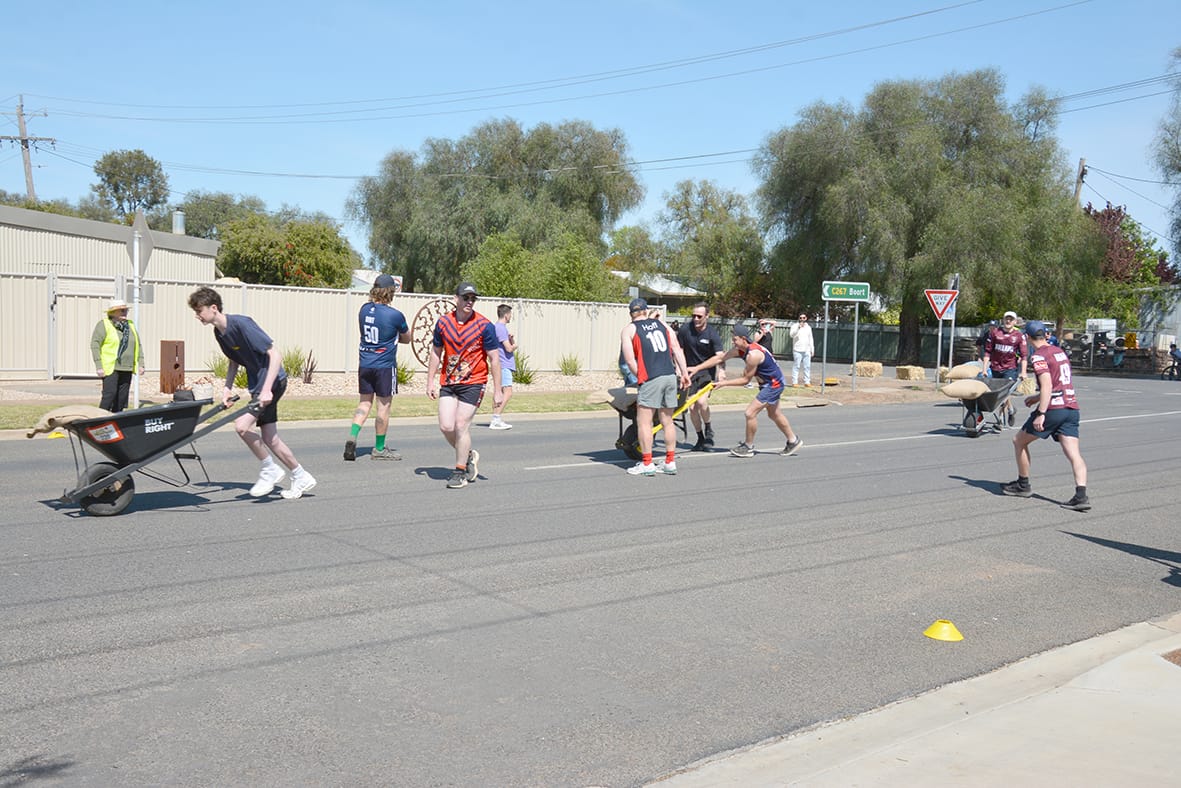 Changing over after the first leg of the Men’s Wheelbarrow relay race. Nully’s Lachlan Braine (second from right) expressed his fatigue, breathing heavily, bent over double saying, “Oh si!t!” Clearly describing the difficulty of pushing 60kg for even a short section of the course.