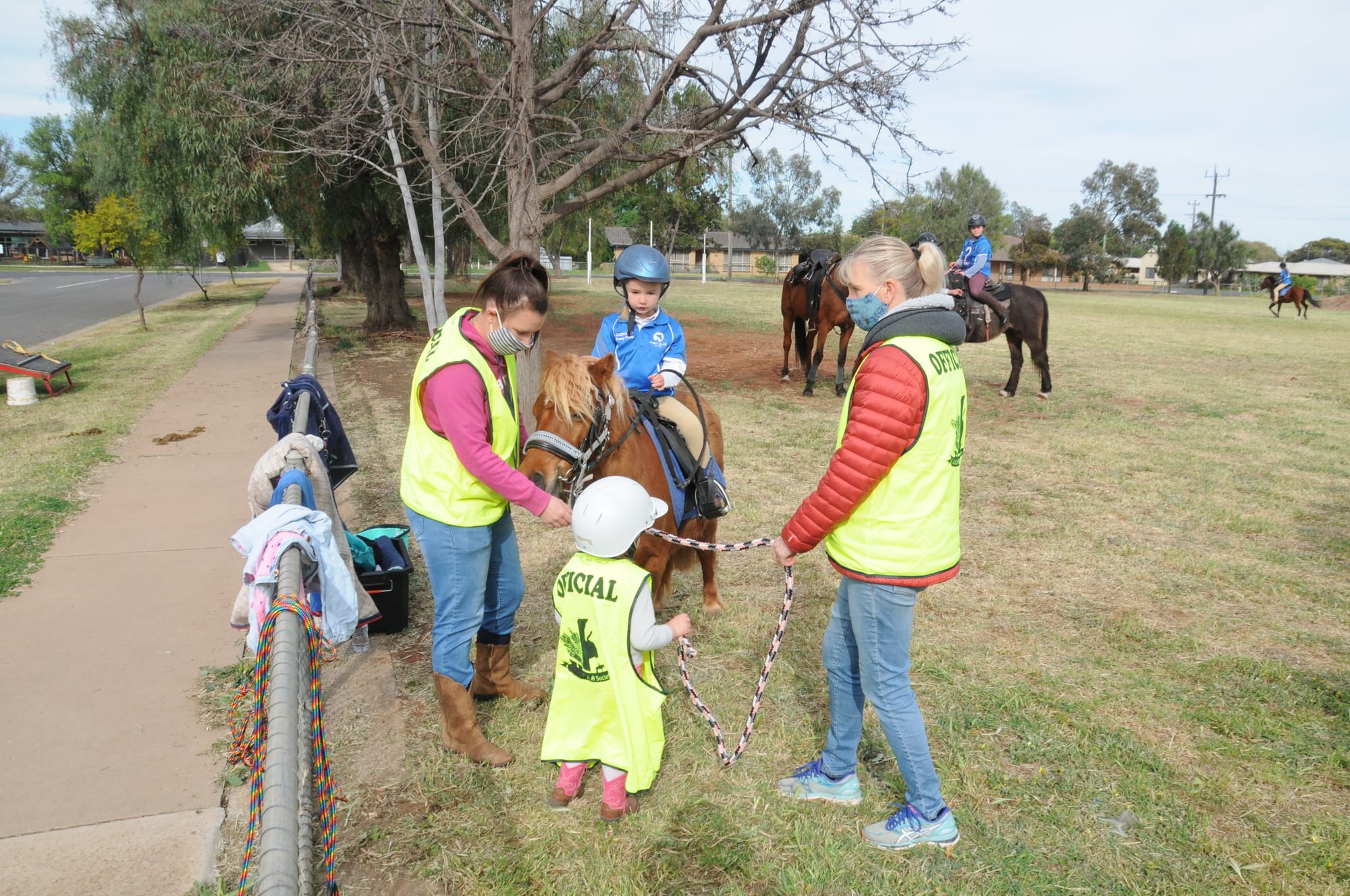 Almost-three-year-old Layla Wheeler (foreground), acting as an official, was on hand to help with the preparation of Donald Pony Club representatives who assisted with the visit of the Melbourne Cup to Donald Primary School on Tuesday. Layla is pictured with her Mum, Kelly James (left), and grandmother, Nicole James, as her four-year-old sister, Stella, gets comfortable in the saddle on “Lily”.