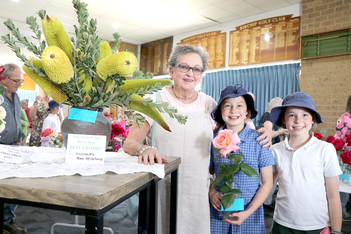 Anne McClelland and granddaughters Frances and Greta McClelland, with their winning flower exhibits.