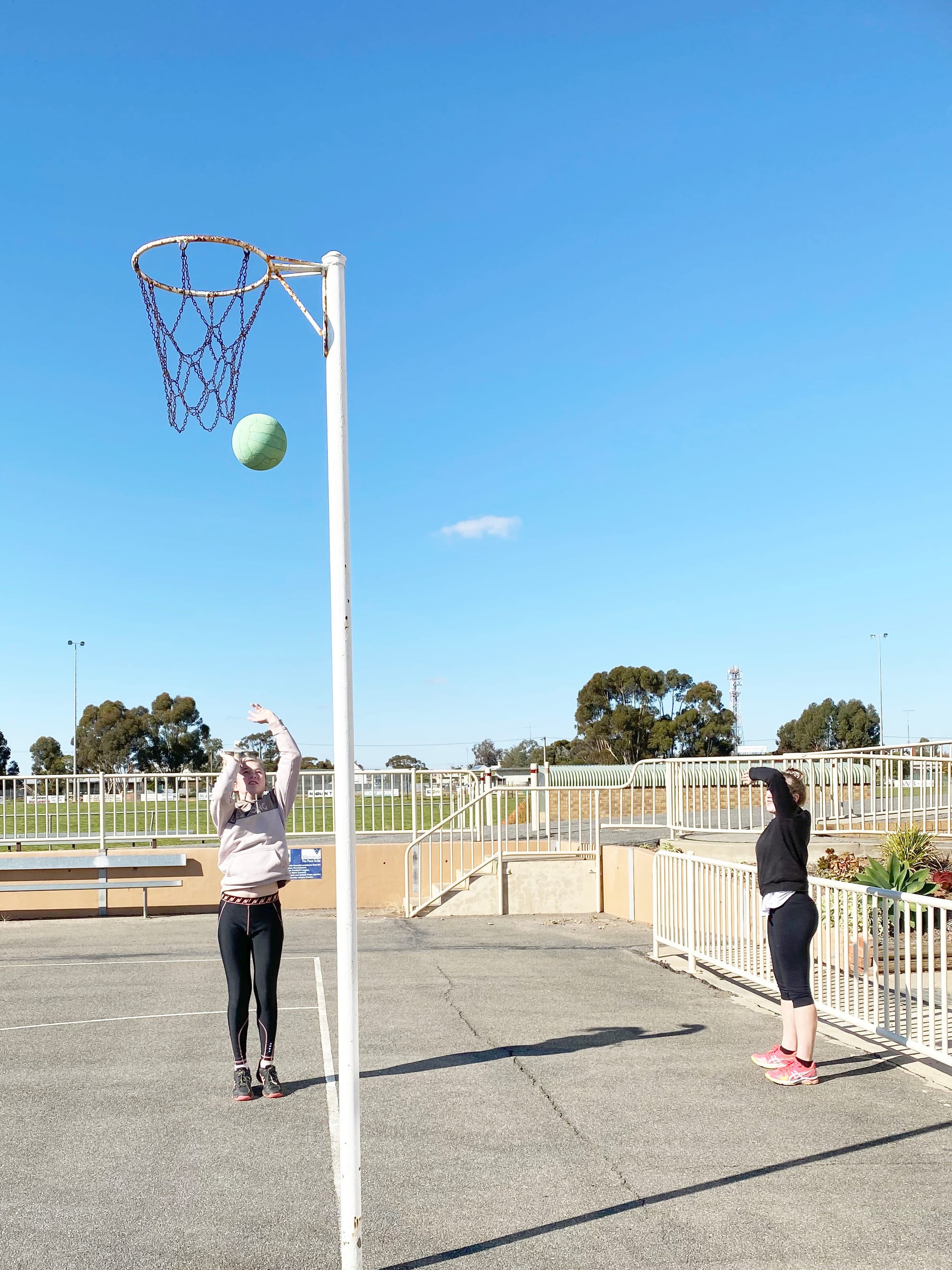Hannah and Maggie Wilson practise their goal shooting.