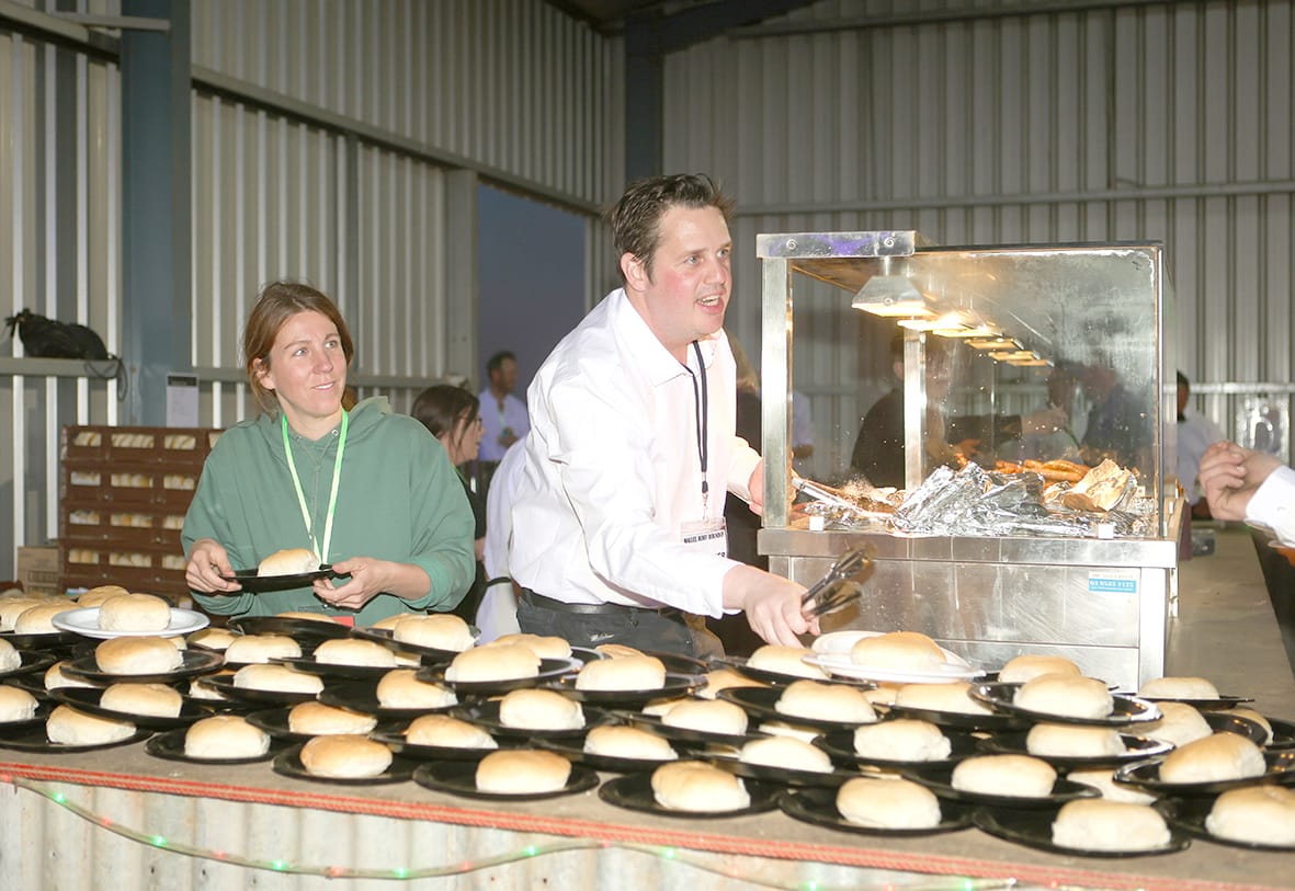Alice Glen and Sam Teggins keep the hungry crowd fed.