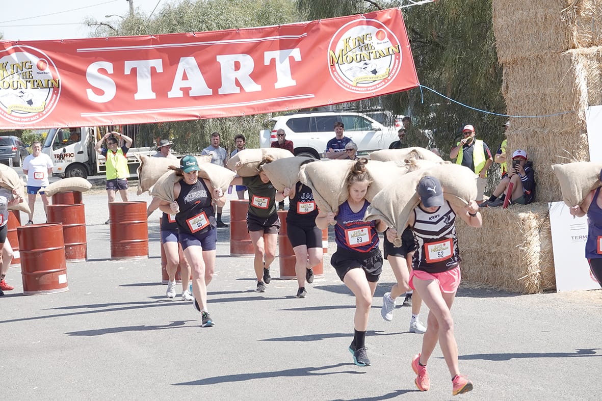 The beginning of the Queen of the Mountain race, with women carrying 20kg of the Mallee's finest wheat to the top of Mt Wycheproof. (Photo by Jodie Drake.)