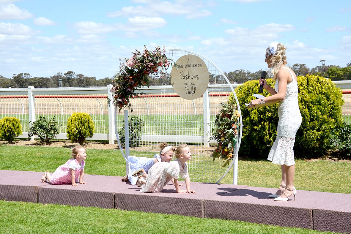 MC Casey Bruce attempts to wrangle kids from the runway prior to the judging of the Lady of the Day category.