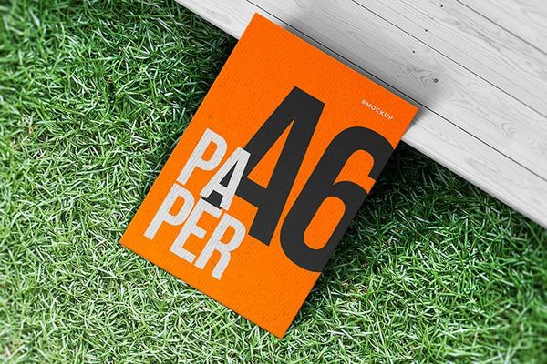 Orange A6 Paper Mockup on Grass Ground