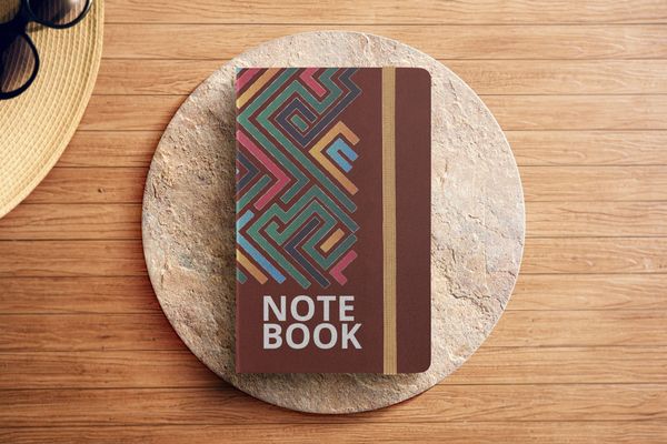 Note Book Mockup with Caput Mortuum Color on Podium
