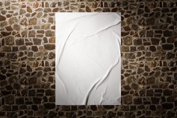Glued Poster Mockup On Rock Wall Background
