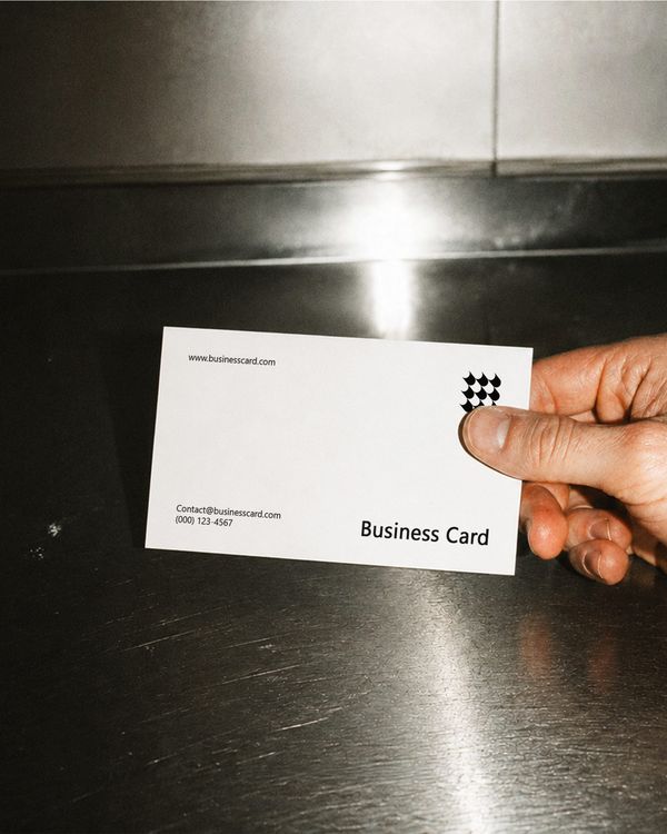 Hand Holding Business Card Mockup Metal Surface Flash Scene