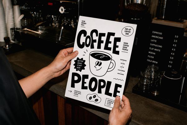 Hand Holding Poster Mockup Coffee Shop Interior Scene