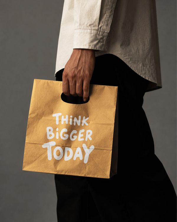 Hand Holding Kraft Shopping Paper Bag Mockup