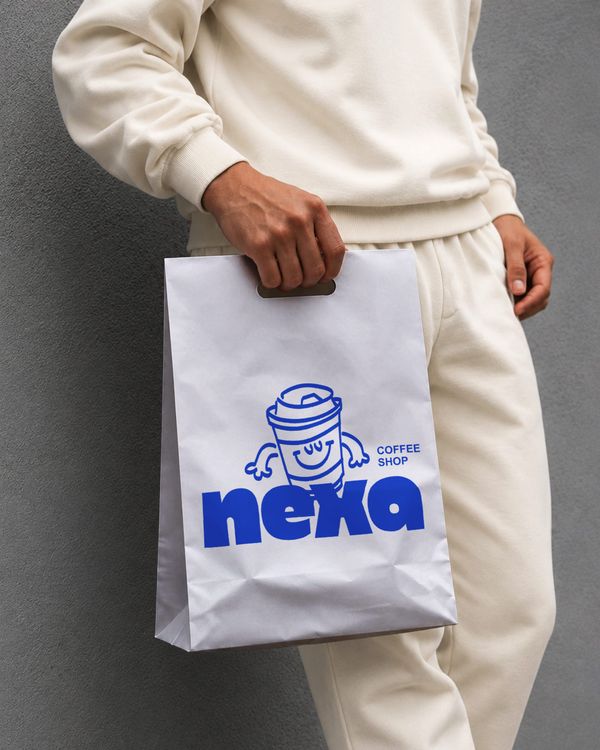 Paper Shopping Bag Branding Mockup Held by Model Against Concrete Wall