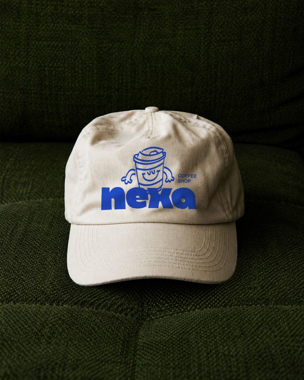 Premium Baseball Cap Branding Mockup on Dark Green Textured Fabric Sofa