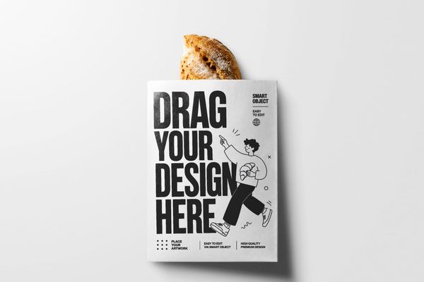 White paper bakery bag holding artisan bread, presented with soft shadows on a minimalist background for premium food packaging and branding presentations.