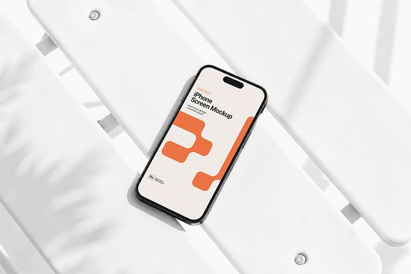 Modern iPhone screen mockup resting on a minimalist white metal bench, creating a clean lifestyle presentation for mobile UI and app design showcases.