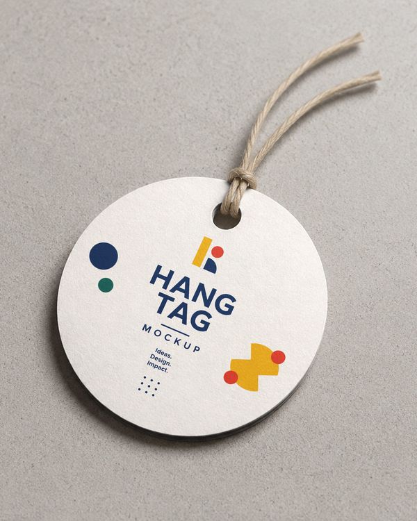 Round textured paper hang tag with natural twine presented on a neutral surface, creating an elegant setting for premium product branding and packaging.
