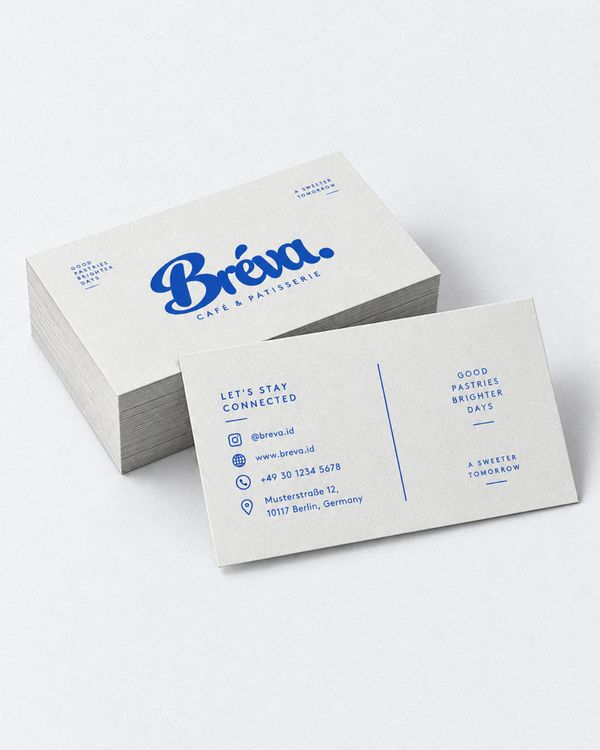 Bakery business card mockup with a stack of white cards and a contact card featuring minimalist blue typography, presented on a clean studio background.