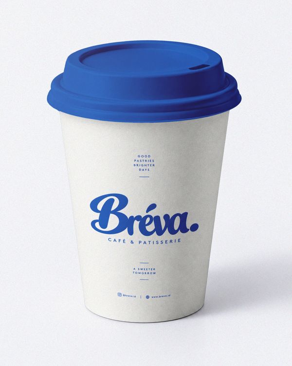 Branded coffee cup mockup featuring a minimalist white takeaway cup with a vibrant blue lid and refined blue typography, presented on a clean studio background.