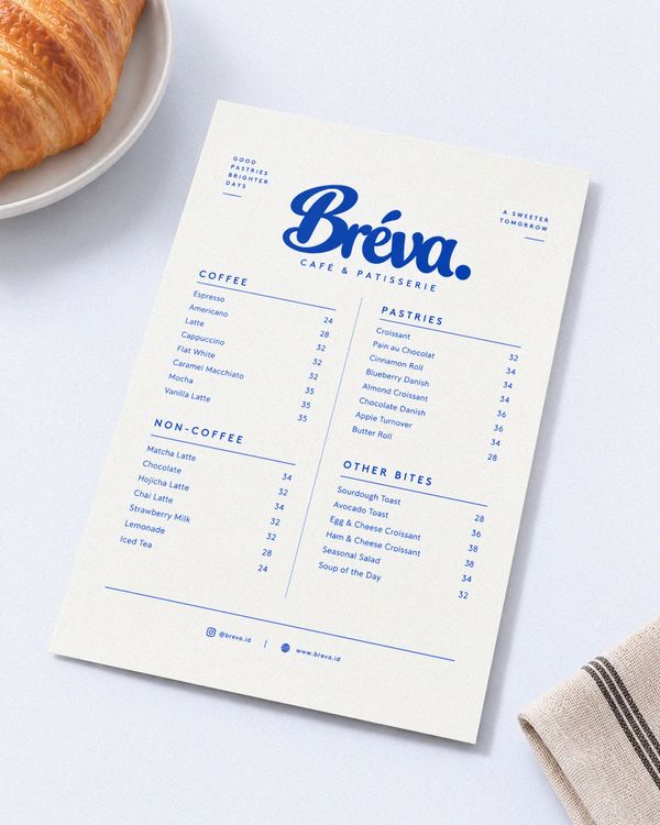 Cafe menu card mockup featuring a clean white menu layout with elegant blue typography and neatly organized food and beverage listings, presented on a bright studio background.