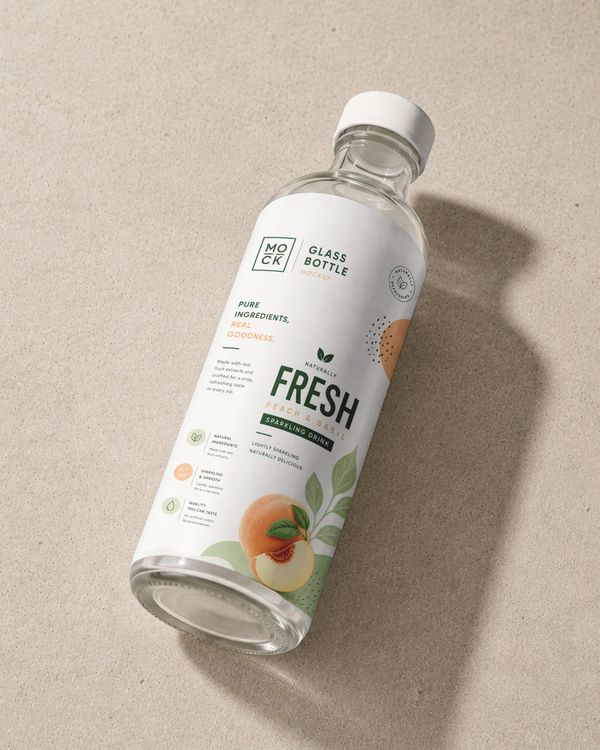 Glass beverage bottle mockup with fresh peach and basil branding for a premium sparkling drink presentation.
